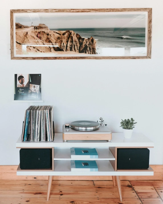 a record player sitting on top of a wooden table, poster art, by Robbie Trevino, unsplash contest winner, minimalism, full room view, coastal, shelves, 📷 mungojerrie and rumpleteazer