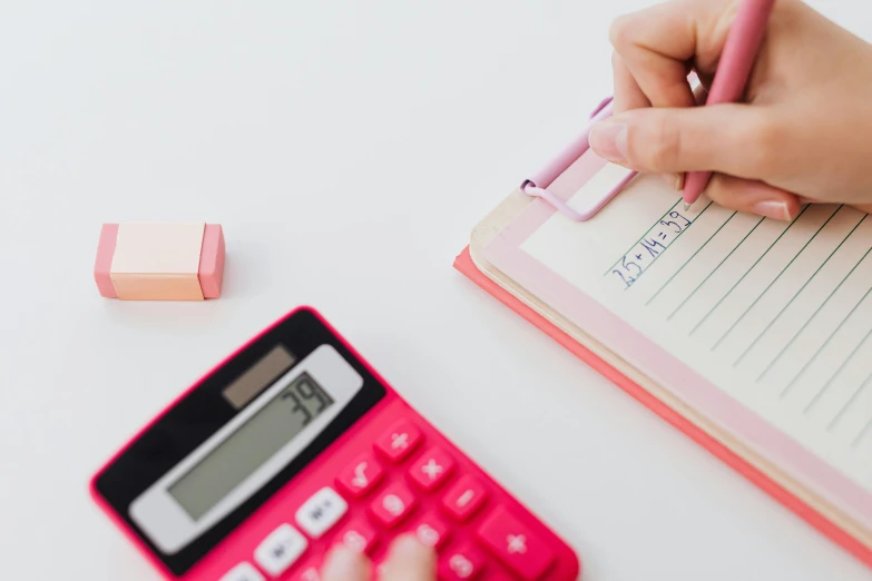 a person writing in a notebook next to a calculator, by Nicolette Macnamara, trending on pexels, pink, thumbnail, inspect in inventory image, schools