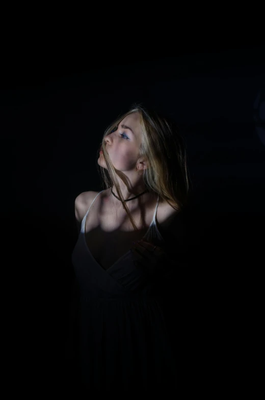 a woman holding a tennis racquet in the dark, an album cover, unsplash, conceptual art, portrait of kim petras, young woman looking up, dark ballerina, shot at dark with studio lights