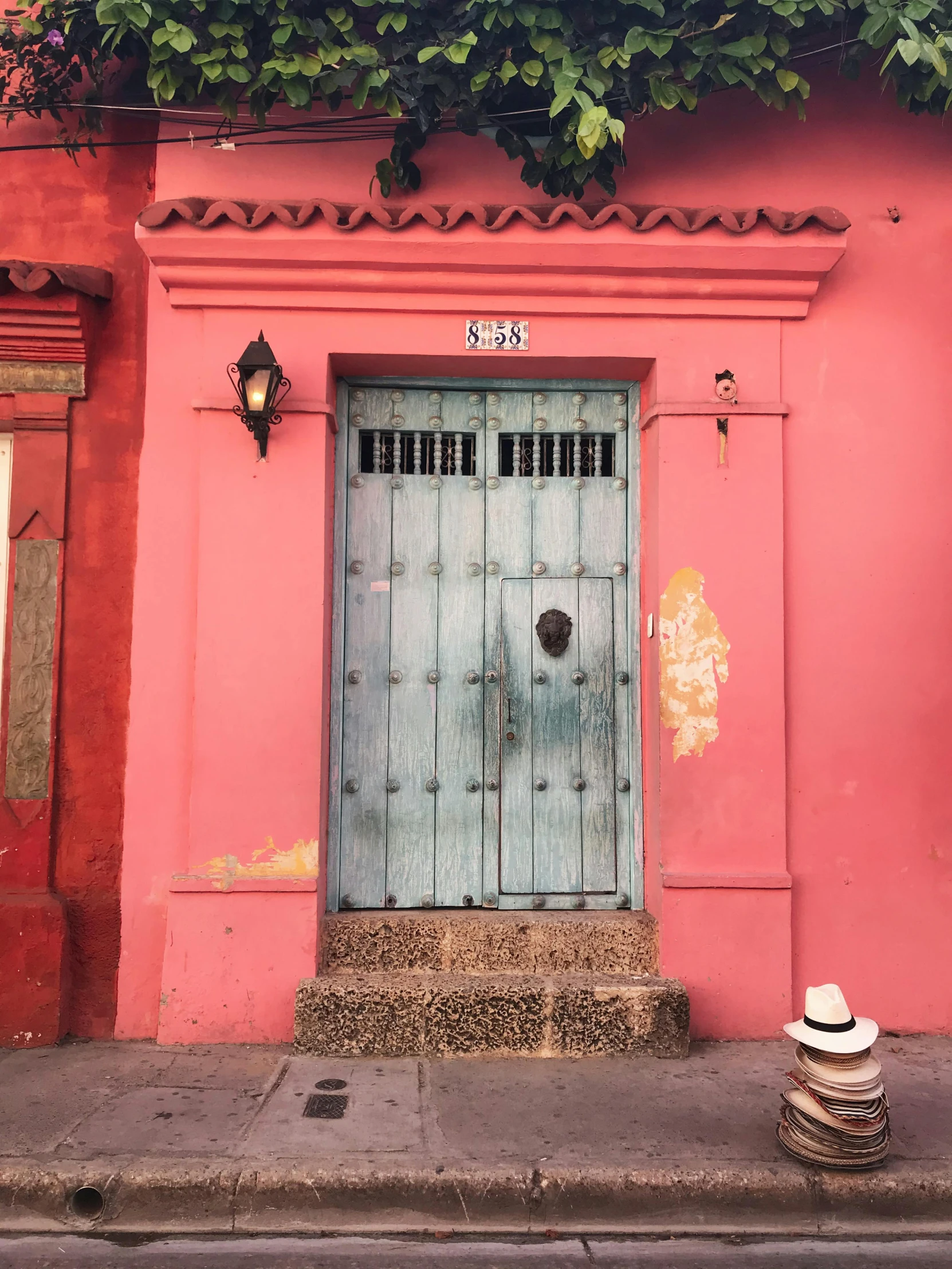 a red building with a blue door and a green door, a photo, trending on unsplash, street art, colombian, light pink tonalities, 🦩🪐🐞👩🏻🦳, conde nast traveler photo