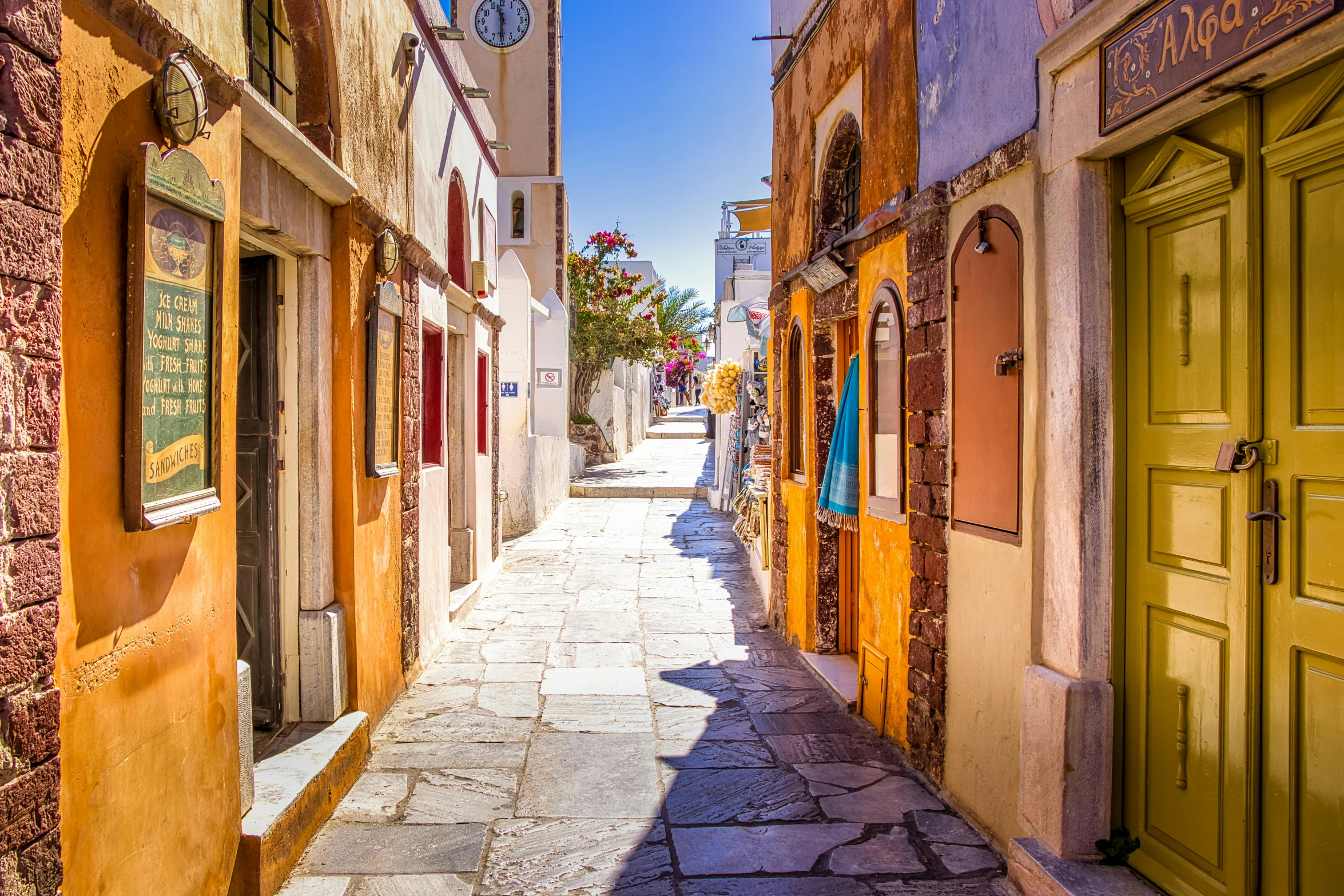 a narrow alley with a clock tower in the distance, pexels contest winner, art nouveau, mediterranean island scenery, thumbnail, ochre, an orgy of colorful