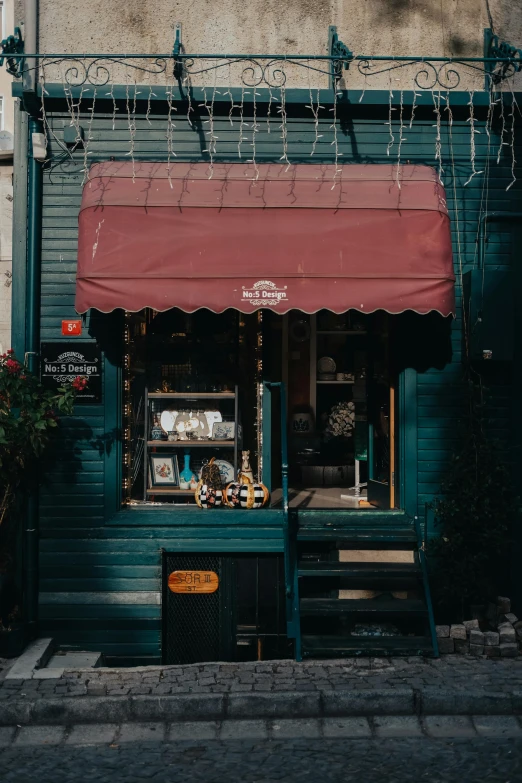 a green building with a red awning in front of it, pexels contest winner, art nouveau, small hipster coffee shop, tattoo parlor photo, moody aesthetic, inside an old magical sweet shop
