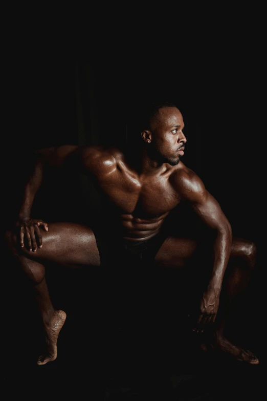 a man sitting on a chair in the dark, an album cover, by Jessie Alexandra Dick, pexels contest winner, bodybuilder body, fully chocolate, dancer, black main color