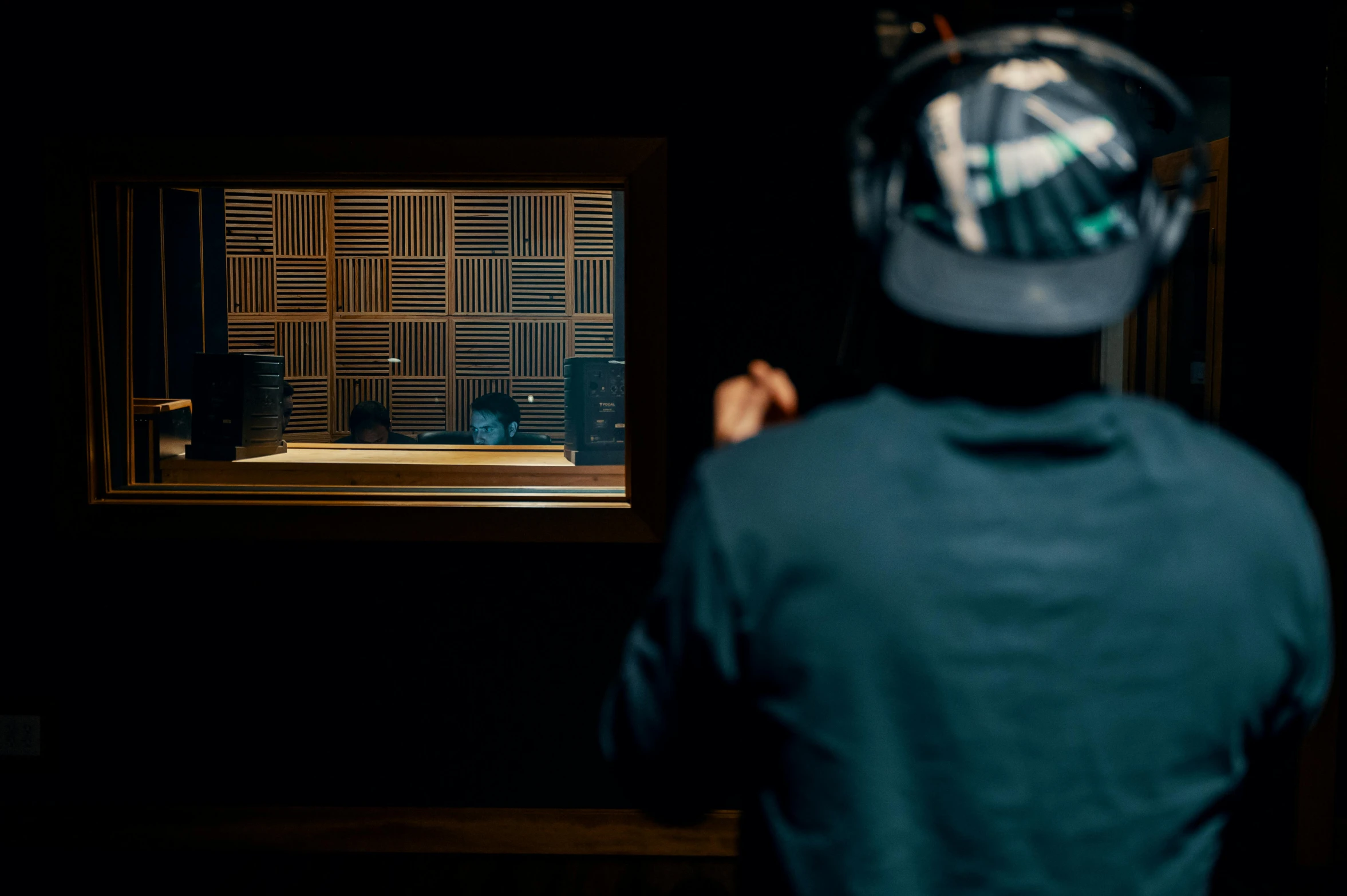 a man that is standing in front of a mirror, an album cover, unsplash, hurufiyya, kyoto studio, looking at monitor, wood headphones, group of people in a dark room