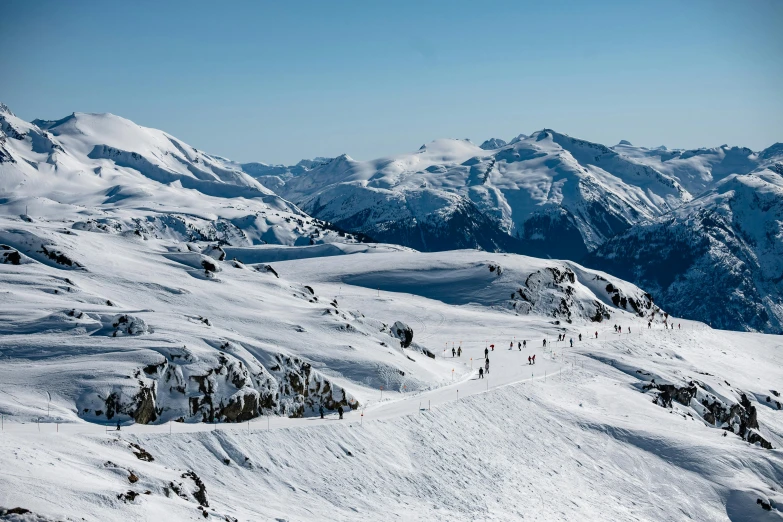 a group of people riding skis down a snow covered slope, by Peter Churcher, pexels contest winner, les nabis, whistler, view from high, thumbnail, granville chandor