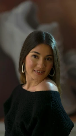 a woman in a black top posing for a picture, karla ortiz, low quality photo, gif, mid shot portrait