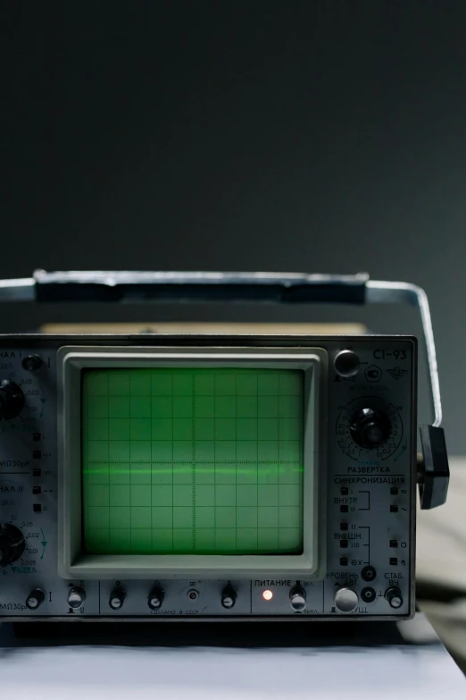 a radio sitting on top of a wooden table, oscilloscope, close - up photograph, 1/400, gameboy
