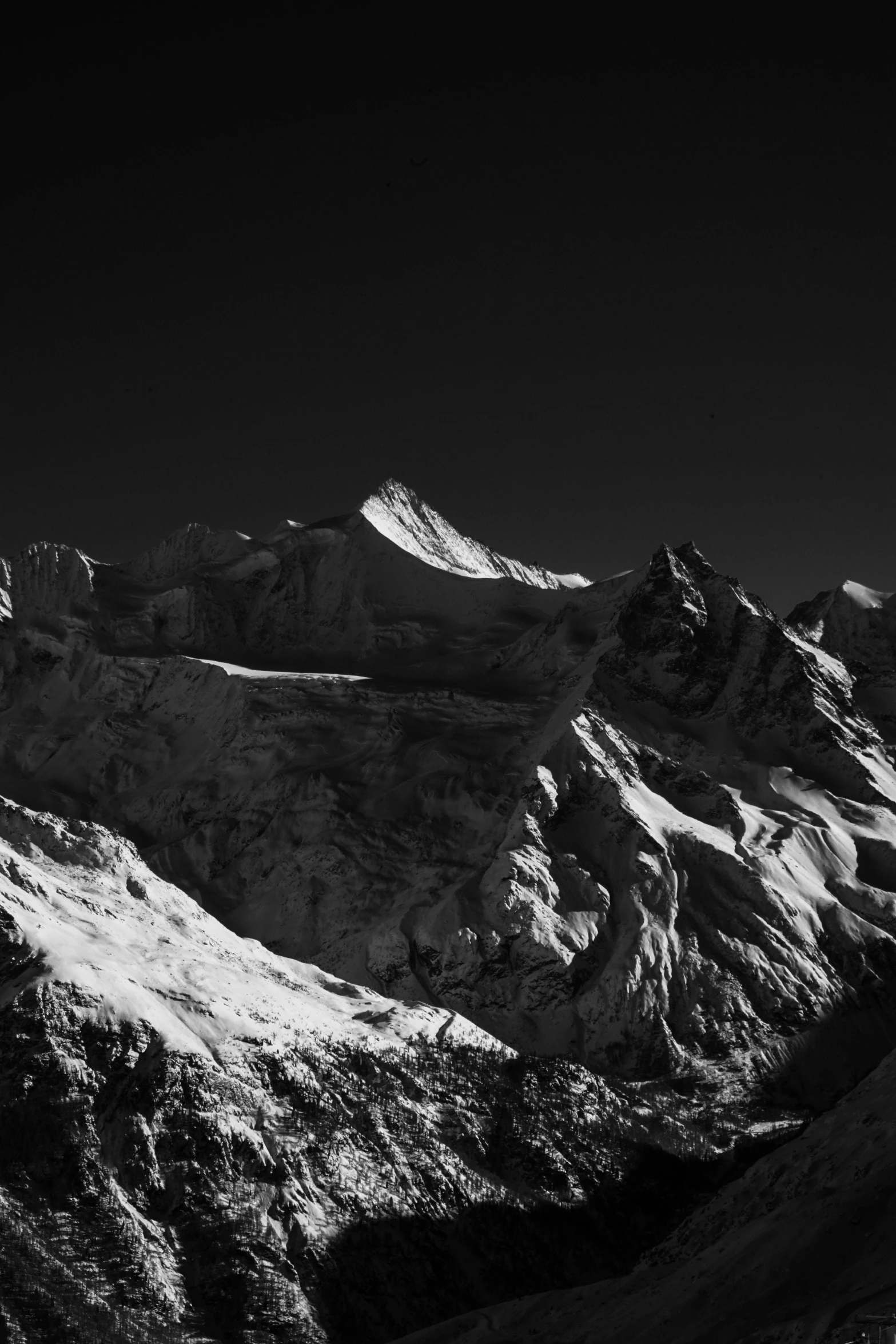 a black and white photo of snow covered mountains, a black and white photo, by Peter Churcher, les nabis, 8 k. volumetric lighting. dark, uttarakhand, medium format. soft light, best on cgsociety