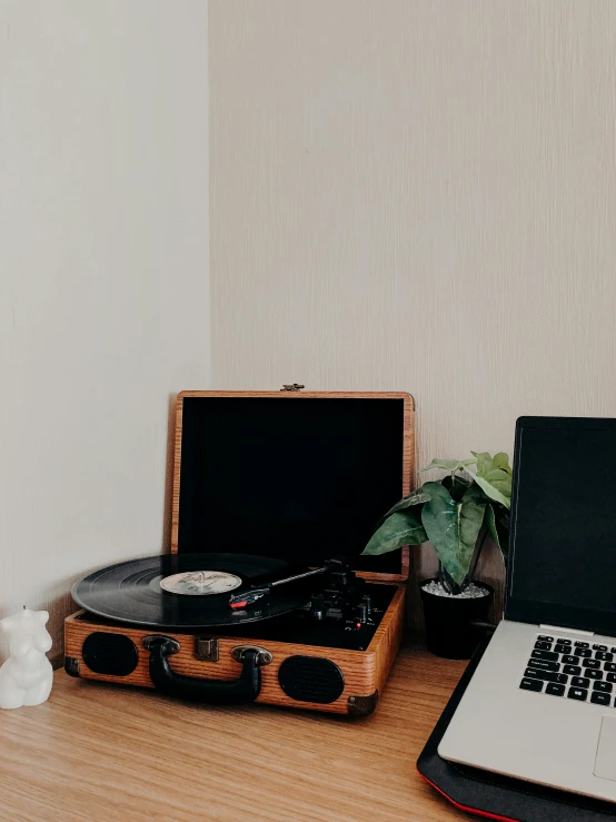 a laptop computer sitting on top of a wooden desk, an album cover, trending on unsplash, aestheticism, djing with dj turntables, detailed product image, old timey, in my bedroom