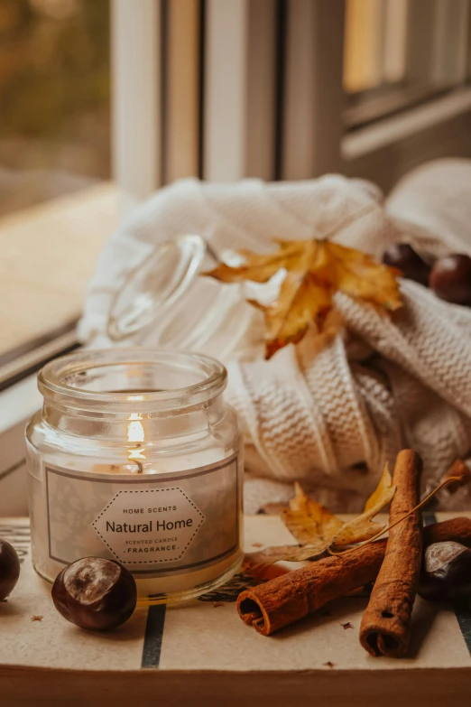 a candle sitting on top of a window sill, fall leaves on the floor, detailed product image, au naturel, thumbnail