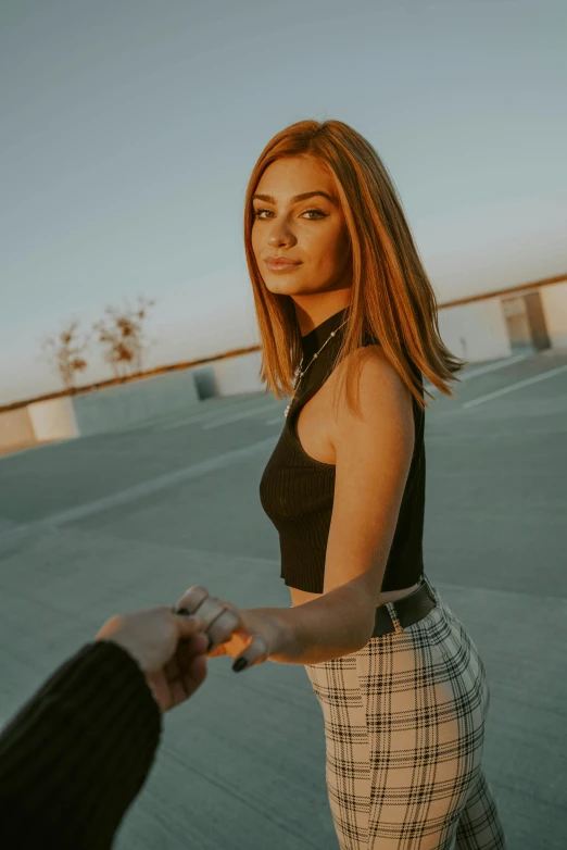 a woman holding a man's hand in a parking lot, a polaroid photo, inspired by Elsa Bleda, trending on pexels, renaissance, wearing crop top and miniskirt, lucy hale, isabela moner, portrait mode photo