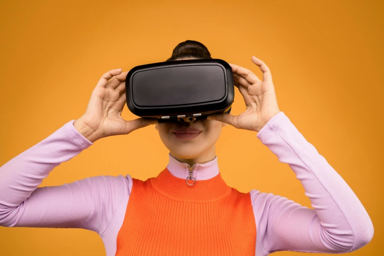 a woman is wearing a virtual reality headset, by Julia Pishtar, trending on pexels, hypermodernism, orange subsurface scattering, close up to the screen, educational, photography of kurzgesagt