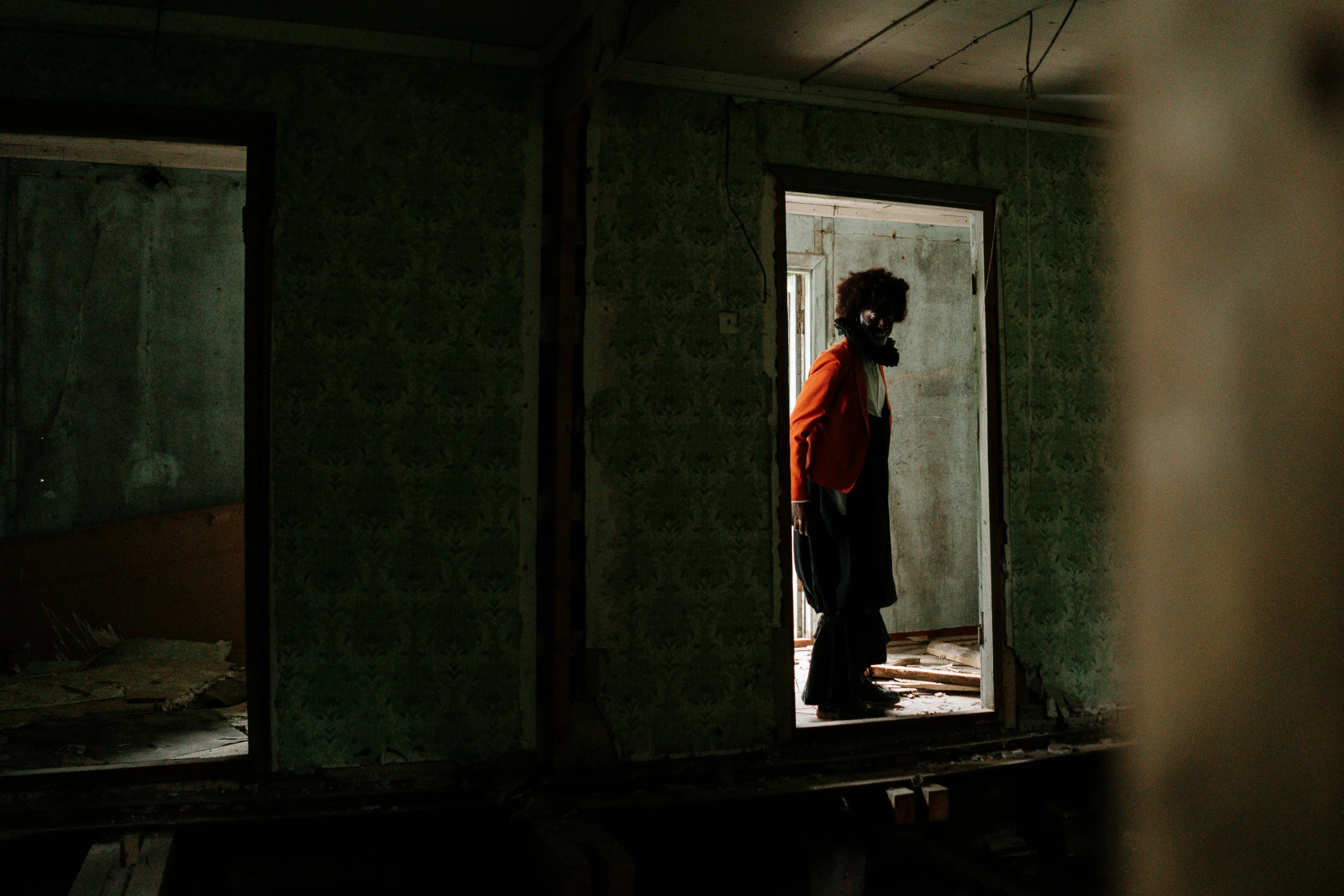 a man that is standing in a doorway, inspired by Elsa Bleda, pexels contest winner, demolition, in a room, woman, yume nikki