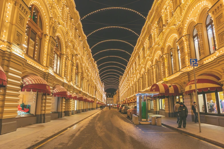 a street filled with lots of lights next to tall buildings, pexels contest winner, art nouveau, kremlin, arcade, symmetrical image, thumbnail