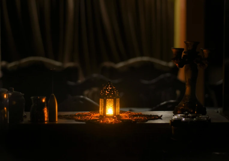 a candle that is sitting on a table, by Riad Beyrouti, pexels contest winner, evil spirits roam with lanterns, sitting in a lounge, dinner is served, dark hazy room