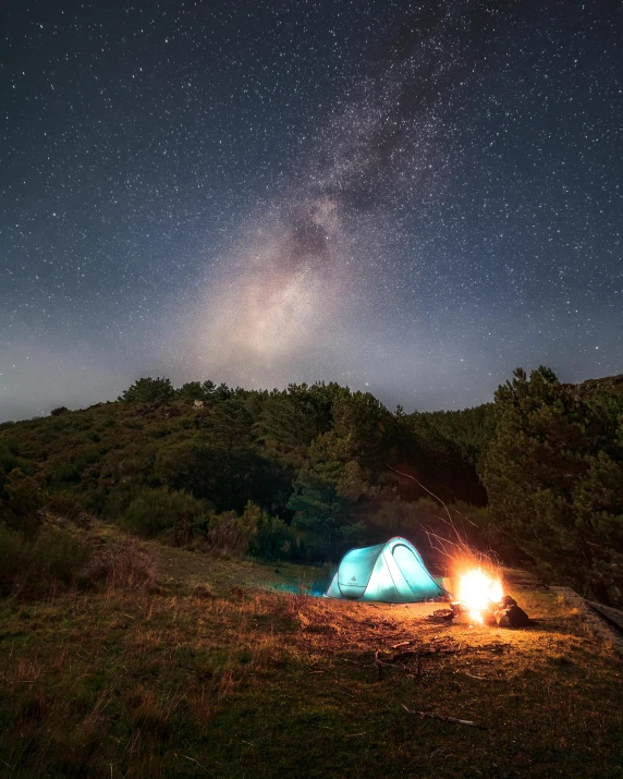 a couple of tents that are sitting in the grass, unsplash contest winner, light and space, fire from sky, galaxy, snapchat photo, trending photo