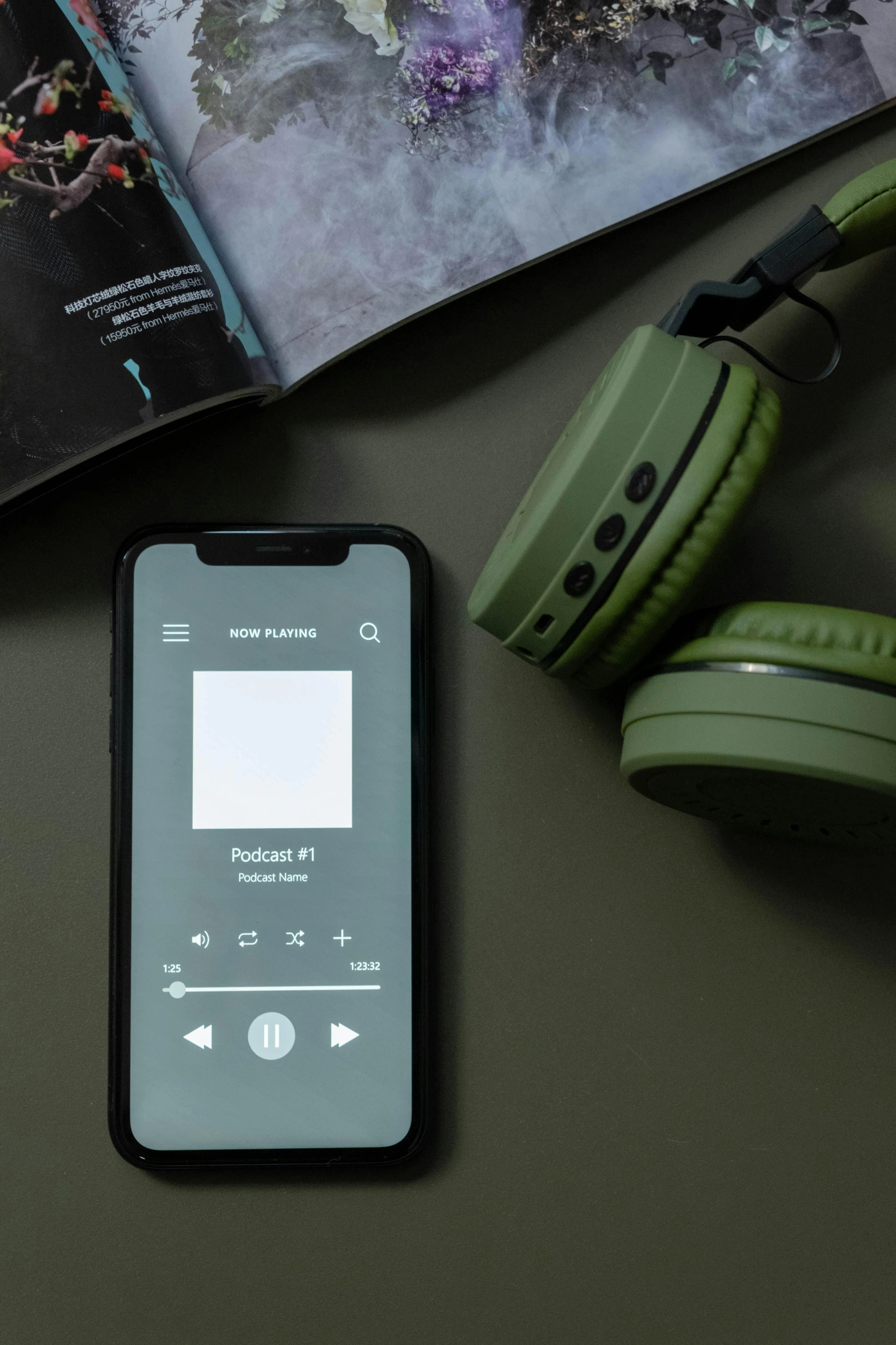 a cell phone sitting on top of a table next to headphones, an album cover, trending on pexels, muted green, no - text no - logo, monochrome, bl