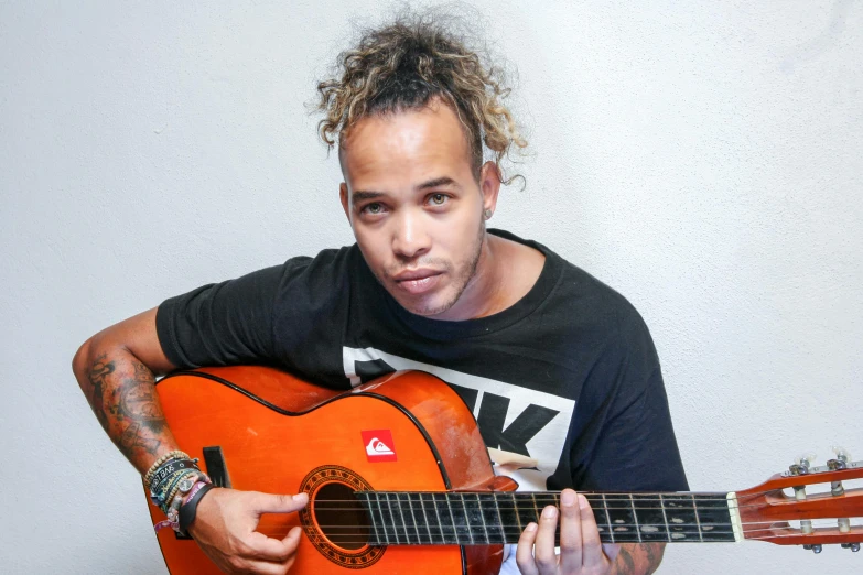 a close up of a person holding a guitar, an album cover, mixed race, smug look, looking towards camera, avatar image