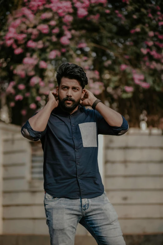 a man in a blue shirt posing for a picture, by Max Dauthendey, pexels contest winner, scruffy looking, jayison devadas style, sunfaded, man standing in defensive pose