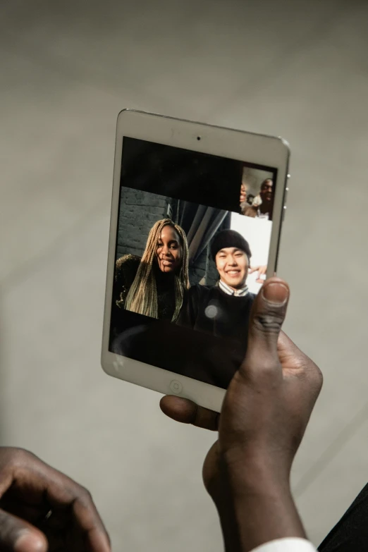 a close up of a person holding a cell phone, a picture, & jeehyung lee & wlop, in meeting together, fujifilm”, square