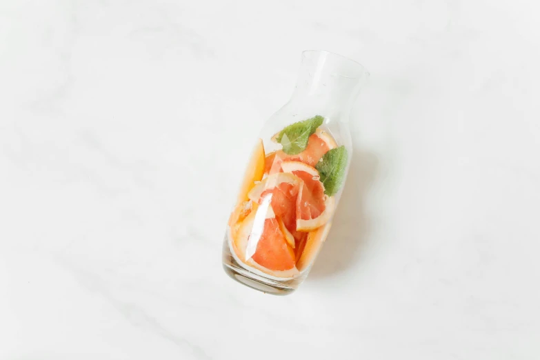 a bottle filled with orange slices and mint leaves, unsplash, process art, glossy surface, full-body, pastel', terrarium