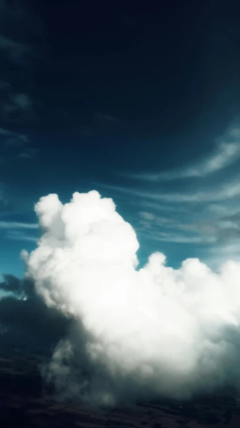 a large white cloud in the middle of a blue sky, unsplash, paul barson, medium format. soft light, smoke from chimneys, cinematic shot ar 9:16 -n 6 -g