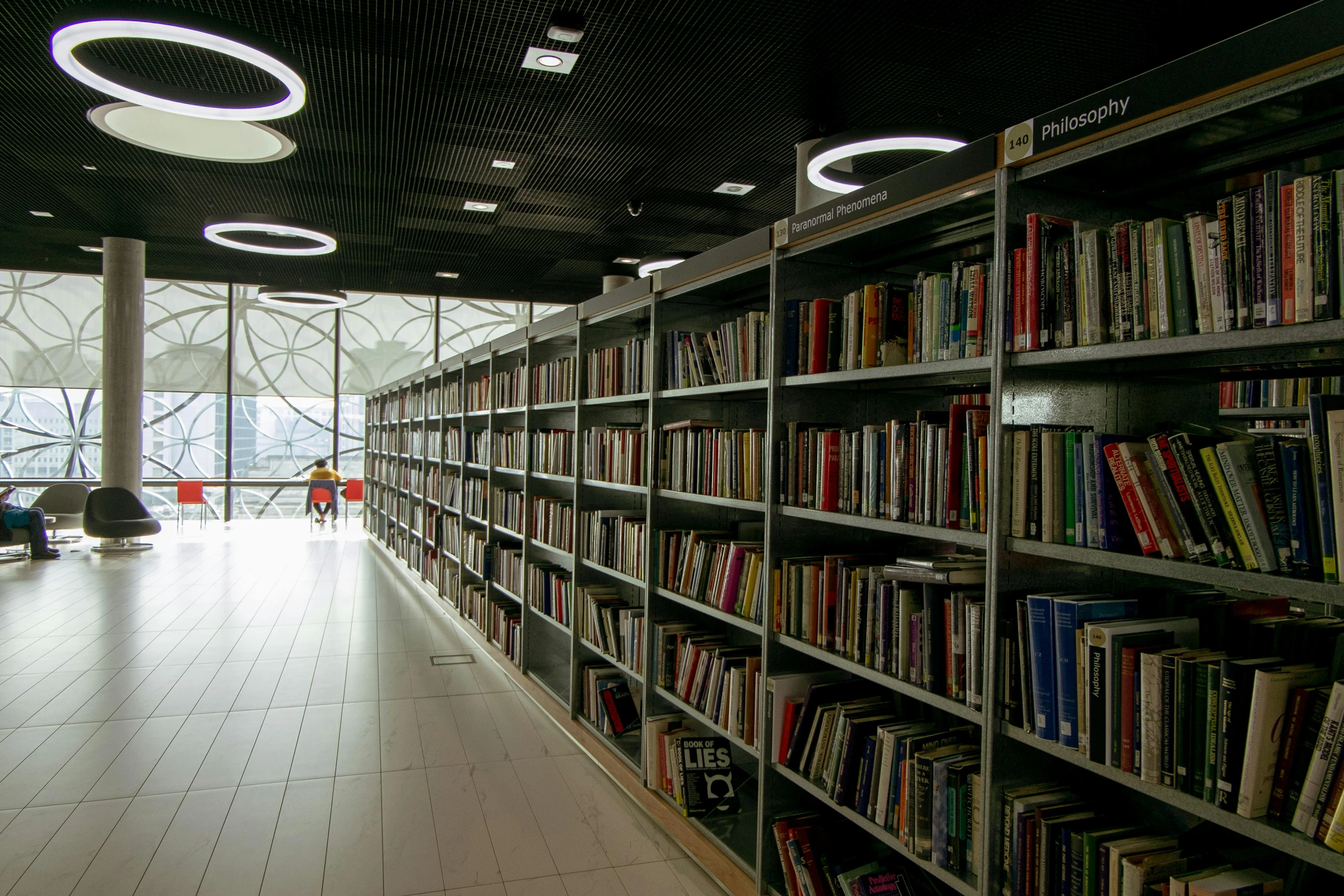 a bookshelf filled with lots of books in a library, pexels contest winner, light and space, long hall way, thumbnail, tehran, terminal