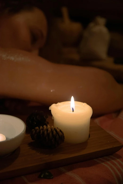 a couple of candles sitting on top of a wooden tray, slide show, asleep, over-shoulder shot, soothing