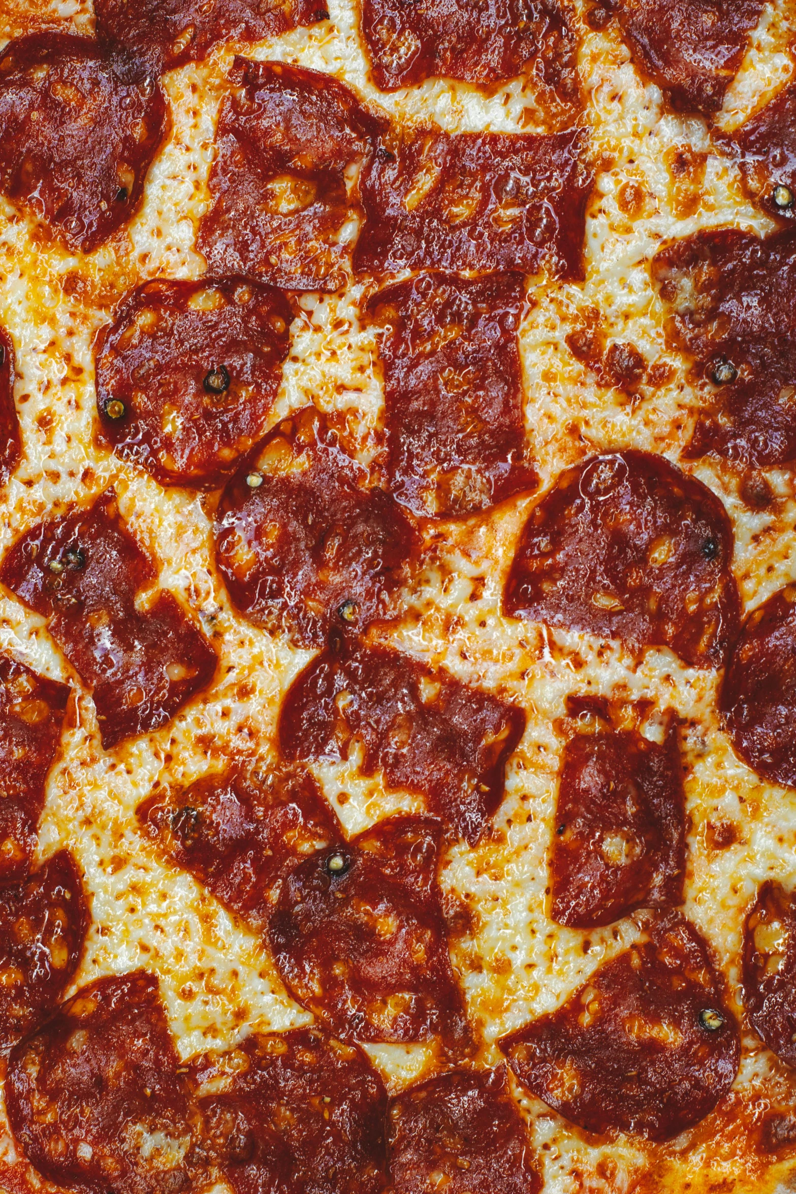 a close up of a pizza with pepperoni on it, an album cover, by Robbie Trevino, full frame image, highly upvoted, a high angle shot, made of glazed