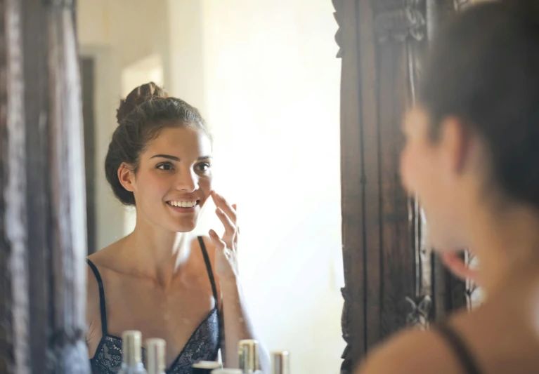 a woman brushing her teeth in front of a mirror, a picture, by Alice Mason, shutterstock, renaissance, photoshoot for skincare brand, taken at golden hour, brunette, without makeup