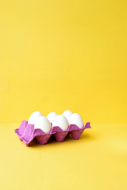 three eggs in a carton on a yellow background, trending on unsplash, pop art, white and purple, six pack, clemens ascher, edible