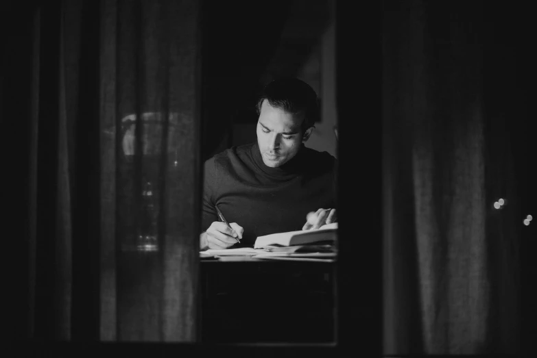 a black and white photo of a man reading a book, by Mathias Kollros, pexels, henry cavill, night mood, writing a letter, avatar image