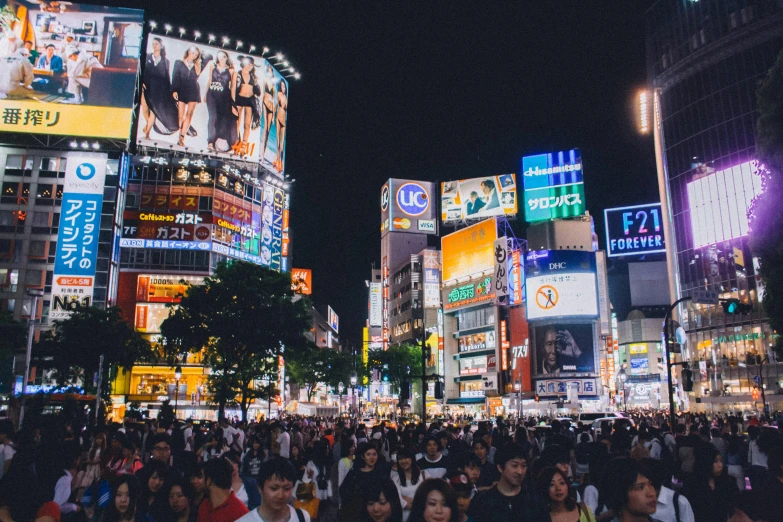 a crowd of people walking through a city at night, a photo, unsplash contest winner, ukiyo-e, neon electronic signs, square, round-cropped, beautiful city