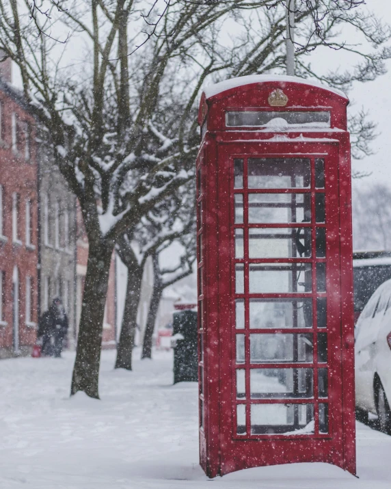 a red telephone booth sitting in the middle of a snow covered street, pexels contest winner, 🚿🗝📝, square, gif, merry england