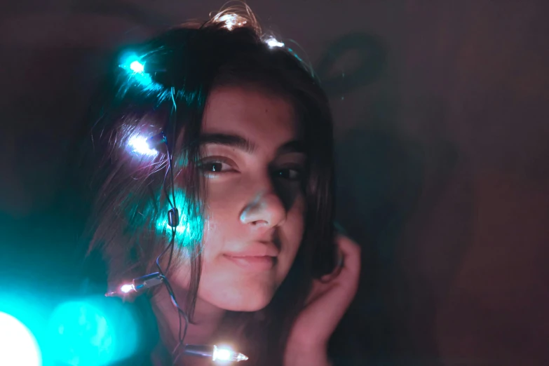 a close up of a woman with lights on her head, a colorized photo, trending on pexels, teen elf, unsplash contest winning photo, lights inside, close body shot