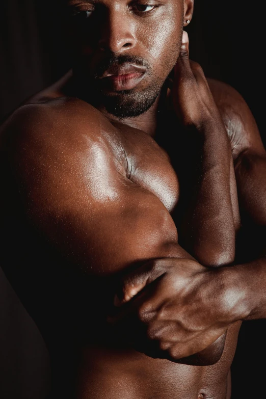 a shirtless man standing in front of a black background, an album cover, by Terrell James, pexels contest winner, closeup of arms, muscular men entwined together, thicc, contemplating