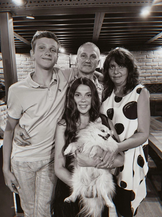 a black and white photo of a family with a dog, a black and white photo, vitalik buterin, taken in night club, taken in 2022, fan favorite