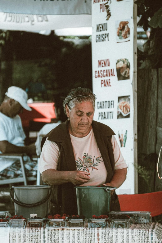 a man that is standing in front of a table, salsa vendor, an old lady, portrait featured on unsplash, people outside eating meals