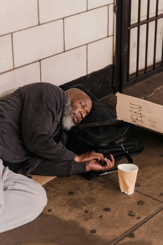 a man laying on the ground next to a coffee cup, trending on unsplash, donald trump as a homeless man, samuel jackson, 15081959 21121991 01012000 4k, two old people