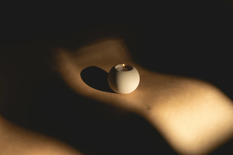 a white egg sitting on top of a table, inspired by Lucio Fontana, unsplash, candlelit, directional sunlight skewed shot, ring lit, organic ceramic white