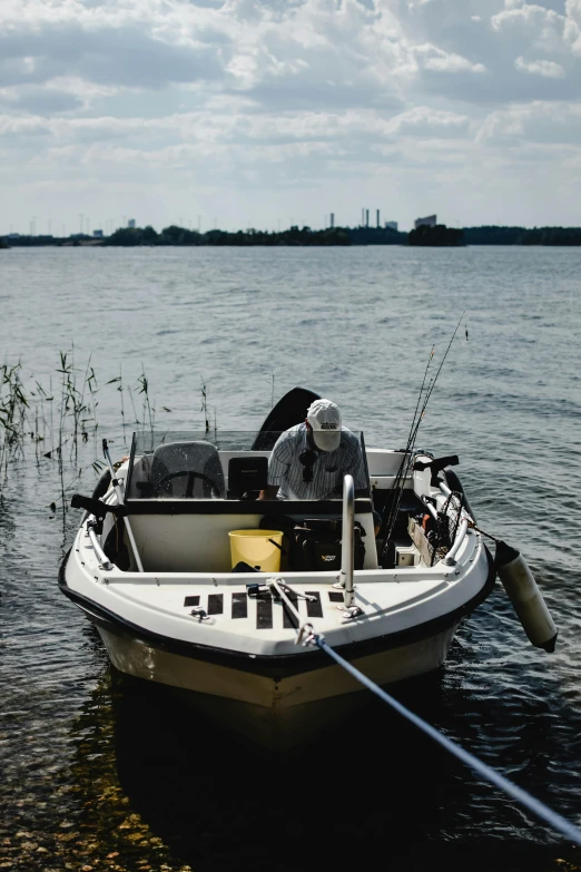 a man sitting in a small boat on the water, hooked - up, scientific study, pristine and clean, 2019 trending photo