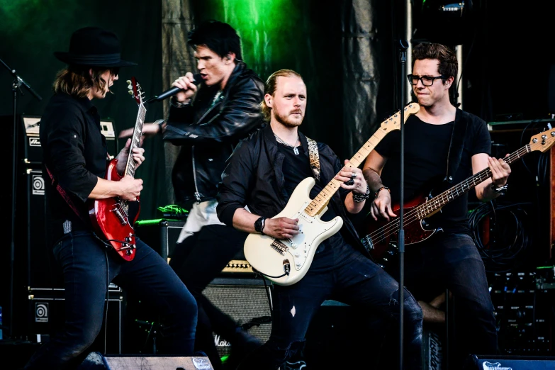 a group of men standing on top of a stage, an album cover, by Jan Pynas, pexels contest winner, playing guitar onstage, black horns, profile image, the panorama