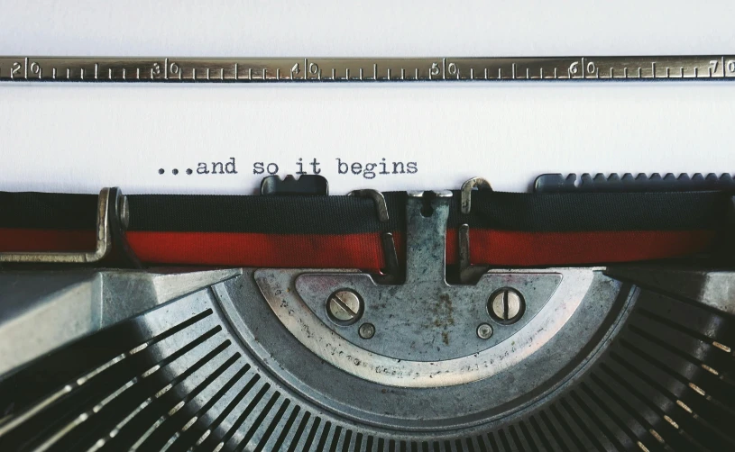 a typewriter with the words and so it begins written on it, an album cover, pexels contest winner, business, regrets, etsy, instagram picture