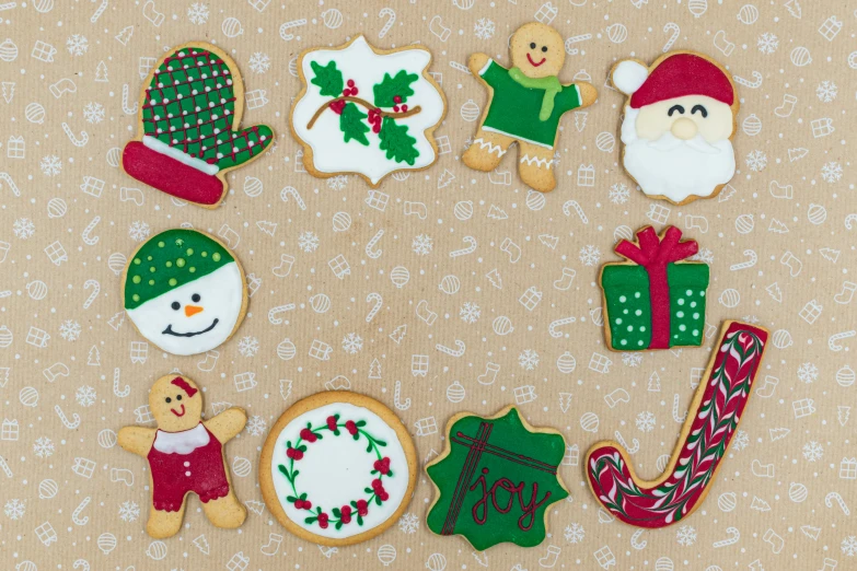 a group of decorated cookies sitting on top of a table, by Sylvia Wishart, pexels, naive art, red green, seasonal, parchment paper, joy