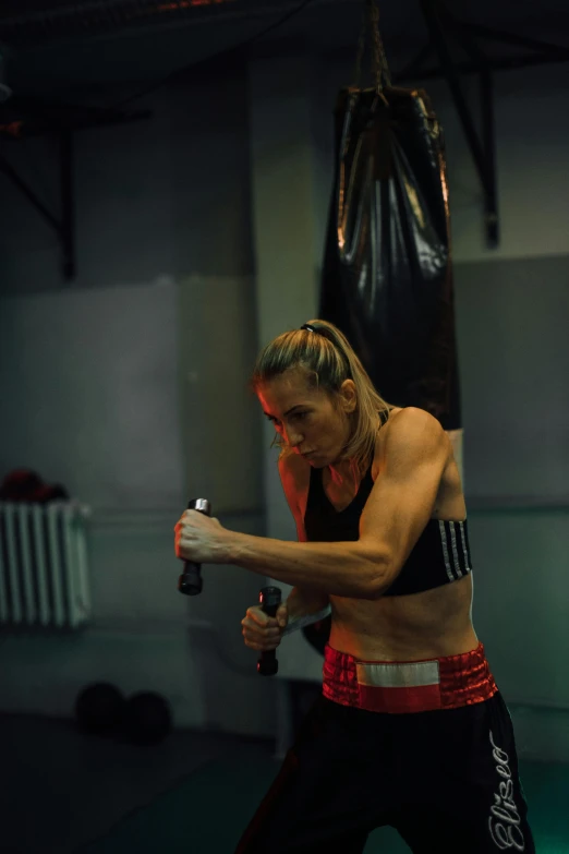 a woman standing next to a punching bag, happening, intense line work, stretch, dasha taran, profile image