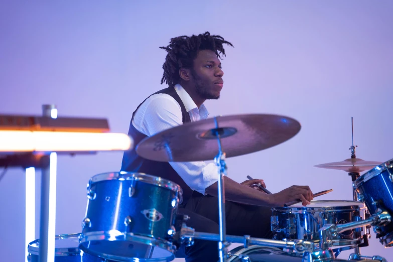 a man sitting in front of a drum set, by Stokely Webster, square, worship, profile, student