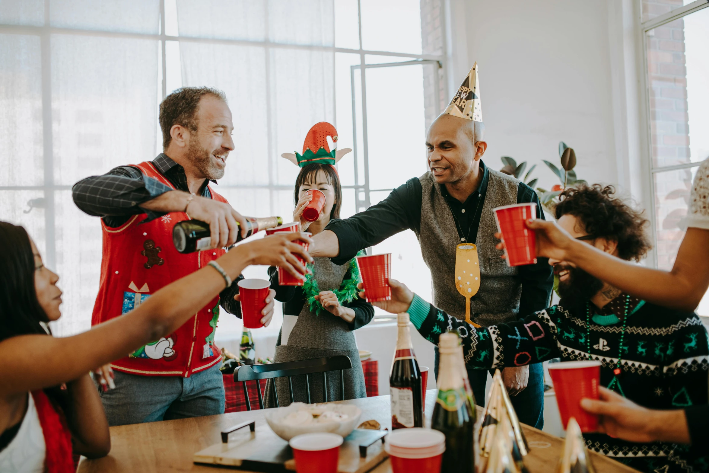 a group of people making a toast at a party, by Carey Morris, pexels contest winner, santa's workshop, wearing a red backwards cap, coworkers, lachlan bailey