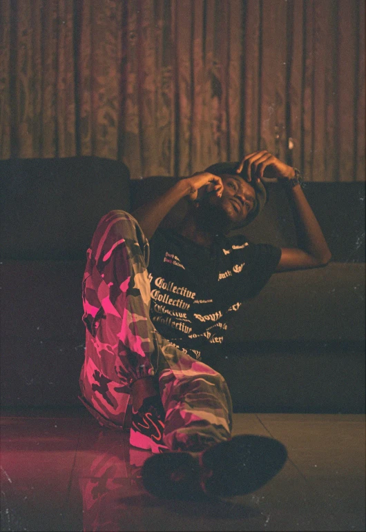 a man sitting on a couch smoking a cigarette, an album cover, by Charles Martin, unsplash, happening, lil uzi vert, distorted pose, (night), grainy