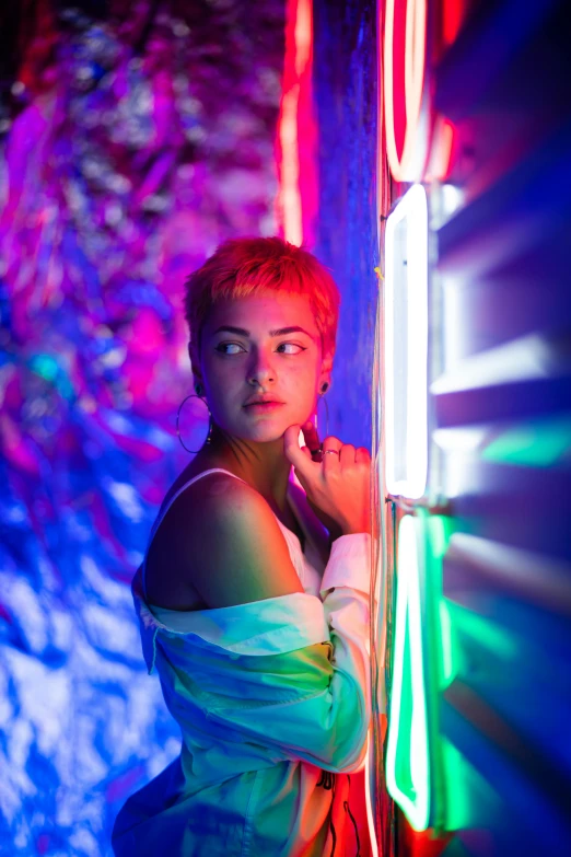 a woman standing in front of a wall with neon lights, inspired by Elsa Bleda, pexels contest winner, neo-fauvism, girl with short white hair, side portrait of imogen poots, iridescent tubes, androgynous person