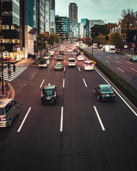 a street filled with lots of traffic next to tall buildings, japanese city, instagram post, trans rights, paved roads